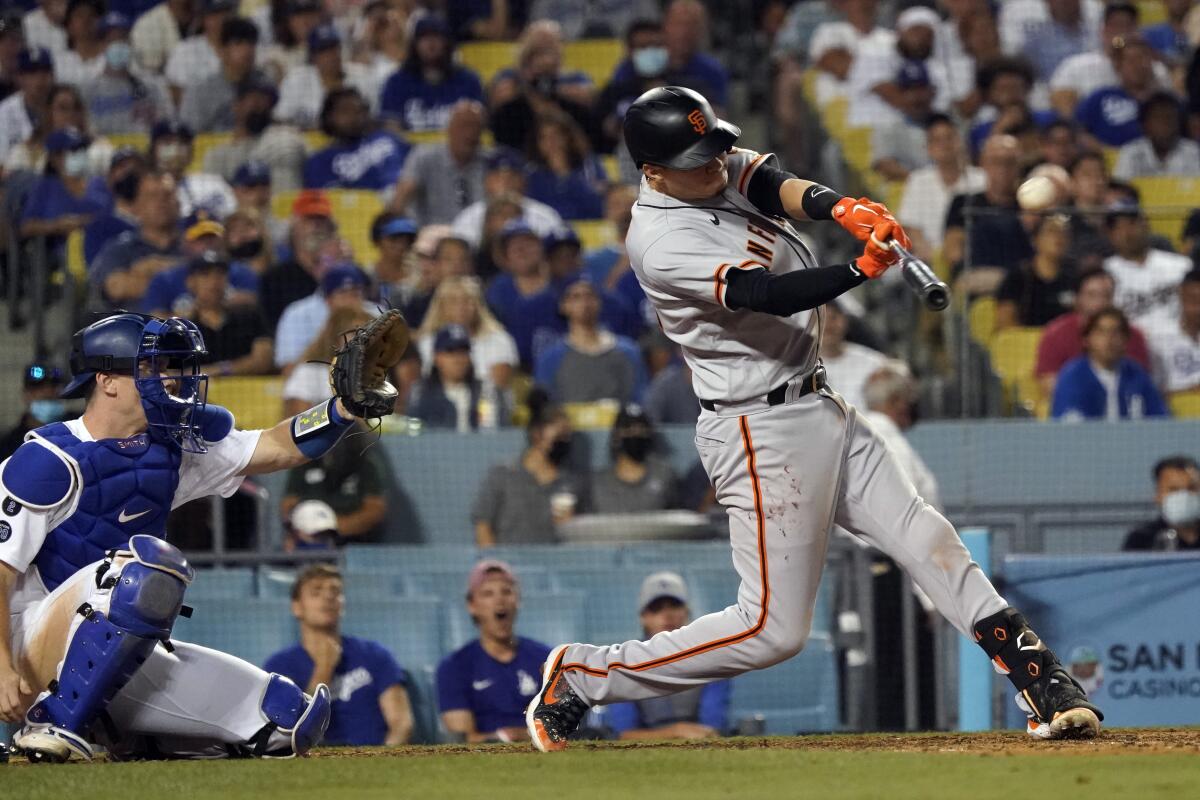 San Francisco Giants' Wilmer Flores connects for a two-run home run off of Dodgers relief pitcher Kenley Jansen.