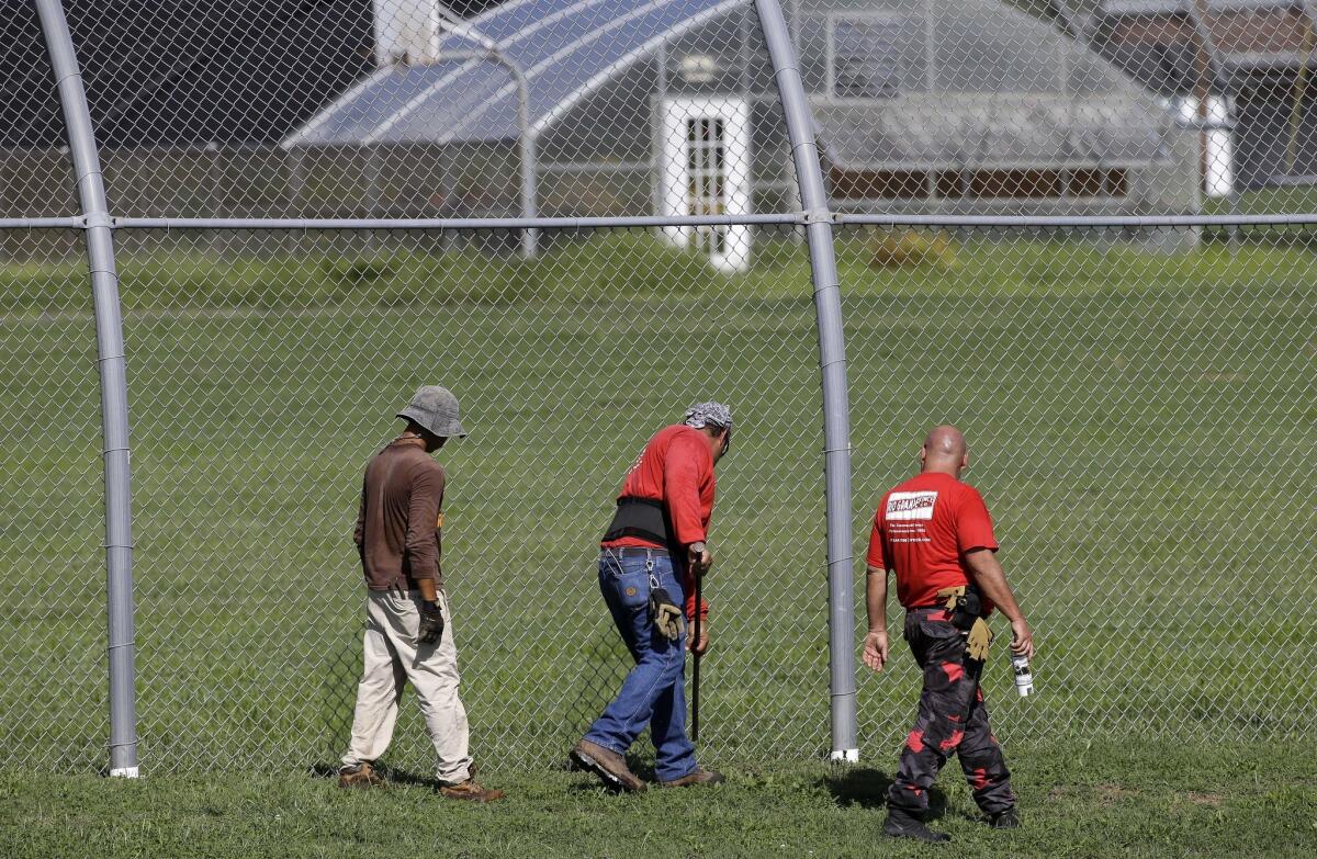 A crew checks for weak spots in the fence surrounding the Woodland Hills Youth Development Center in Nashville Sept. 2.
