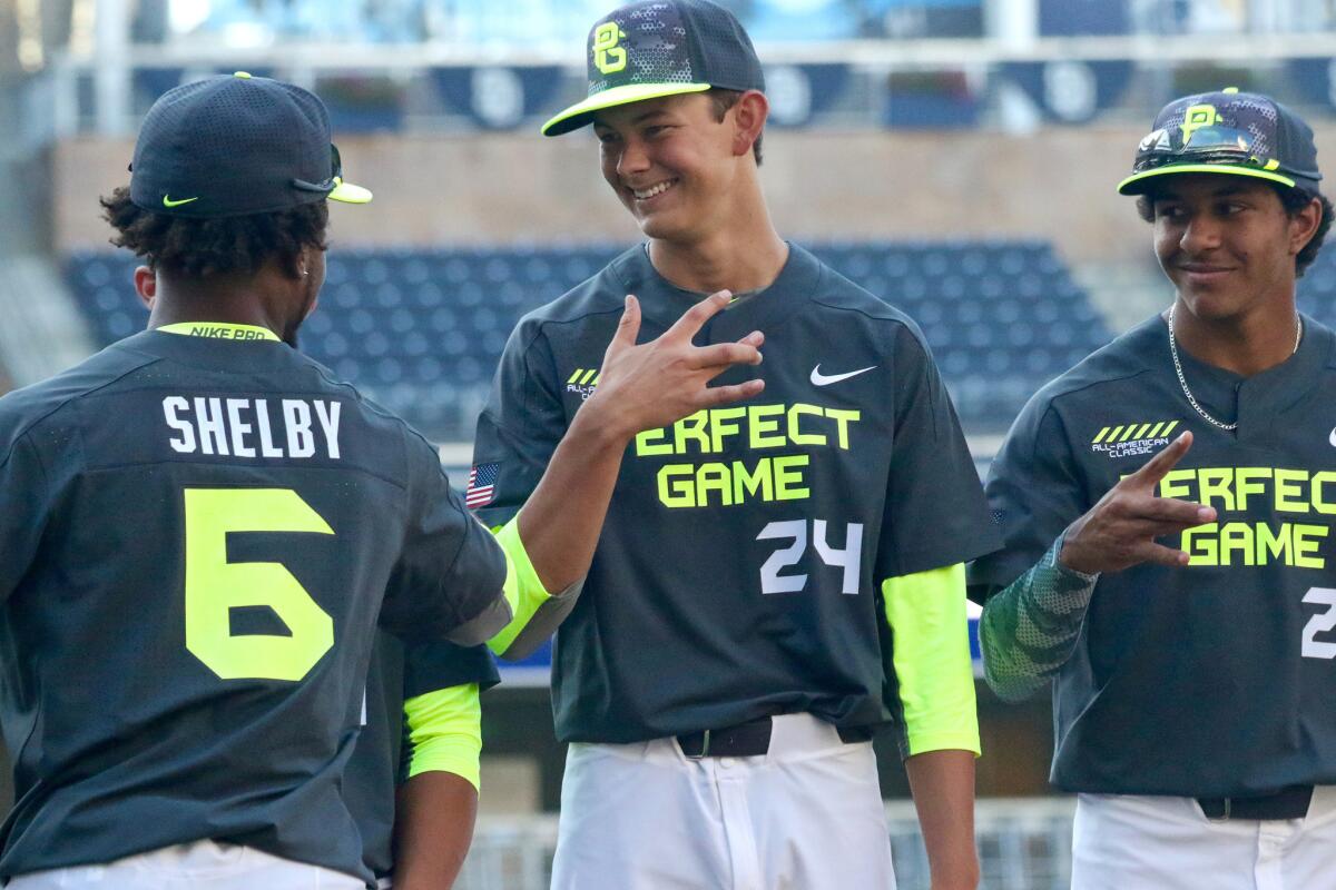 Santa Barbara High pitcher Kevin Gowdy, center, shares a laugh during pre-game introductions at the Perfect Game All-American Classic in San Diego in 2015.