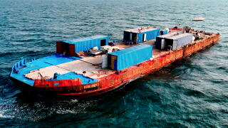 In 2022, Samuele Landi bought a 800-ton deck barge that he named Aisland and anchored about 30 miles off the coast of Dubai.