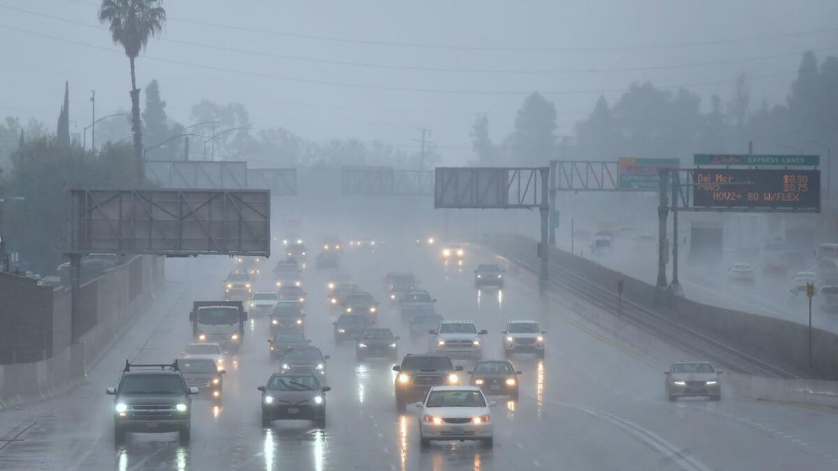 Commuters drive in the rain in Los Angeles on Wednesday.