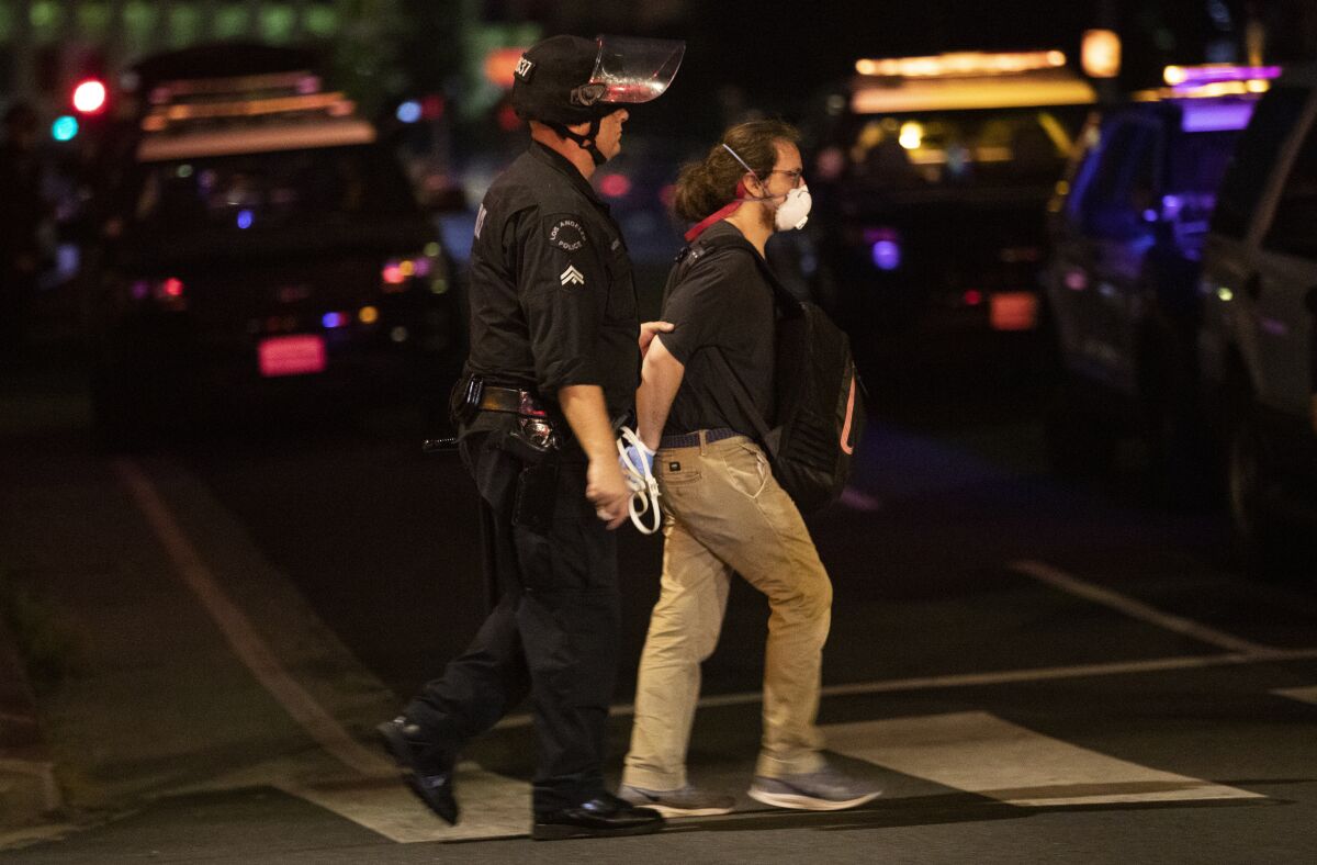 A protester is arrested by Los Angeles police after curfew on June 2.