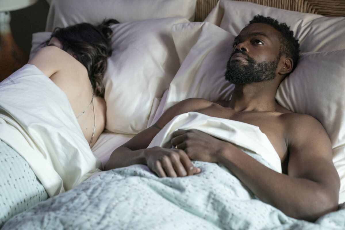 William Jackson Harper lies in bed next to a woman in a scene from "Love Life."