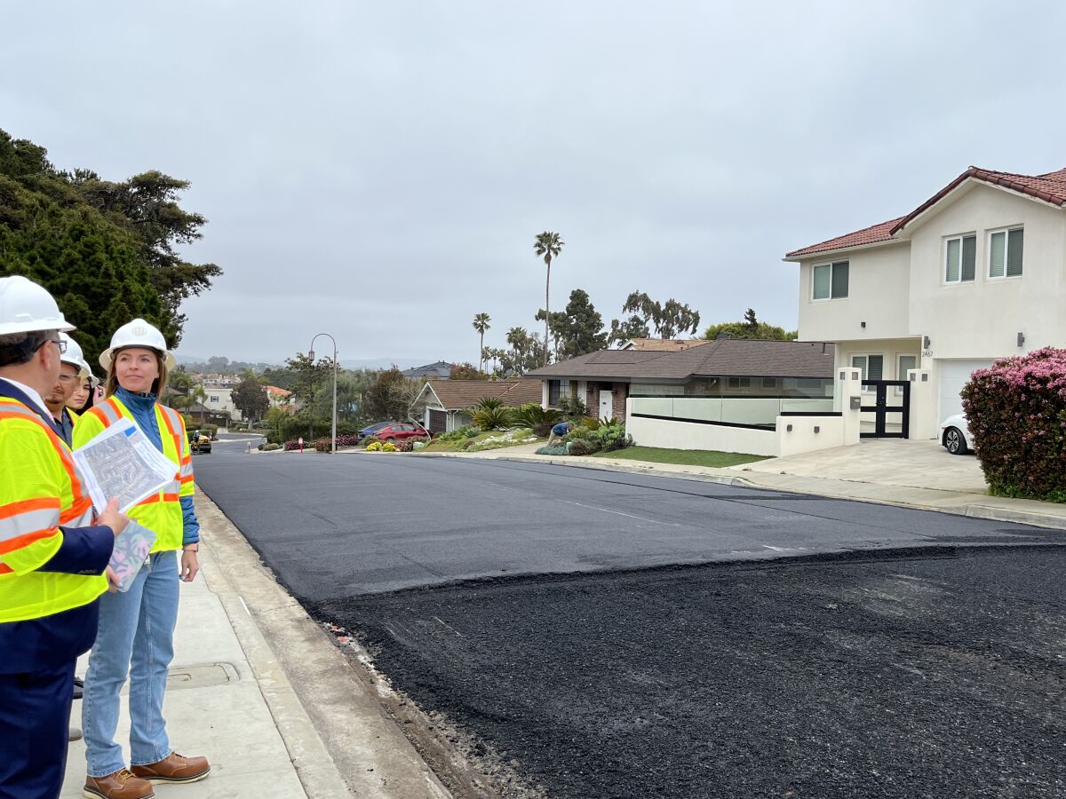 The asphalt overlay consists of a new layer of asphalt atop the existing street, a thickness of one to two inches.