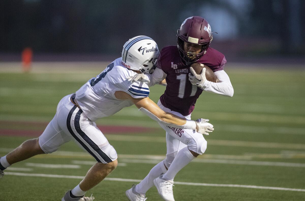 Laguna Beach's Jackson Rodriguez is stopped by Northwood's Adam Harper during a nonleague game on Friday.