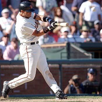 San Francisco Giants' Pedro Feliz hits a grand slam off Los Angeles Dodgers reliever Yhency Brazoban to break a 5-5 tie in the eighth inning on Saturday, Sept. 25, 2004, in San Francisco. The Giants won 9-5.