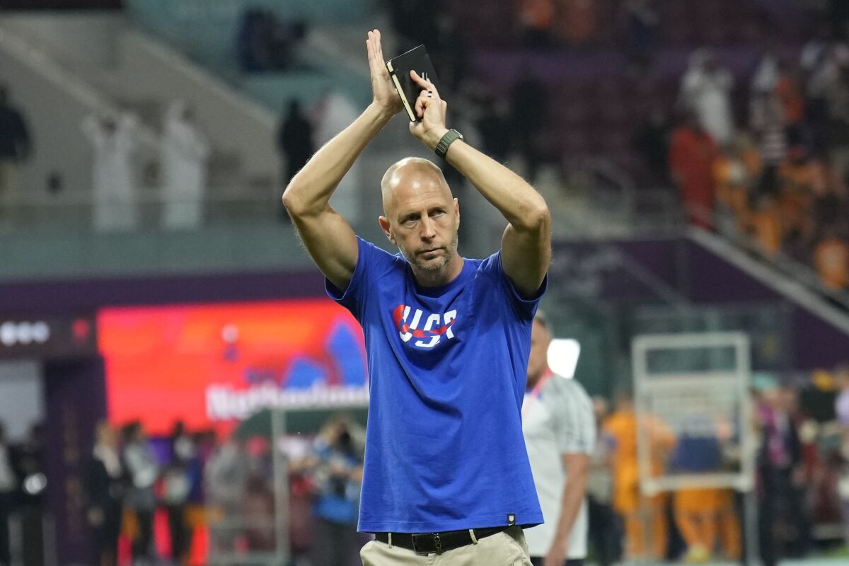 U.S. coach Gregg Berhalter salutes supporters following a loss to the Netherlands at the World Cup on Dec. 3.