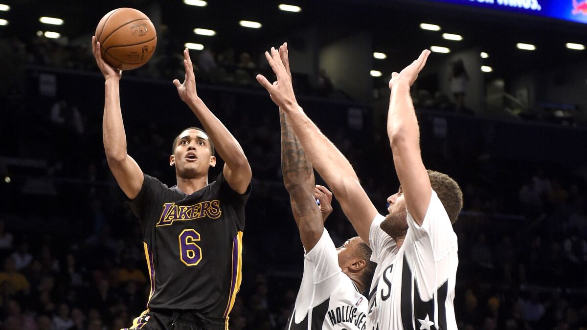 Lakers guard Jordan Clarkson tries to score on a driving layup against Nets forward Rondae Hollis-Jefferson and center Brook Lopez in the first half Friday night.