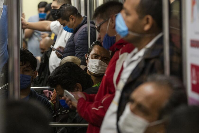 MEXICO CITY, MEXICO - APRIL 17: Commuters ride the subway wearing face masks after the authorities established the mandatory use of face masks inside the subway on April 17, 2020 in Mexico City, Mexico. Mexico is under health emergency, which implies that only essential activities are permitted. Government suggested population to stay at home but quarantine is not obligatory as there is major concern about the economic activity. Hugo Lopez-Gatell Undersecretary of Prevention and Health Promotion announced the extension of the measures until at least, May 30 in those cities with a bigger risk and number of contagion. (Photo by Cristopher Rogel Blanquet/Getty Images)