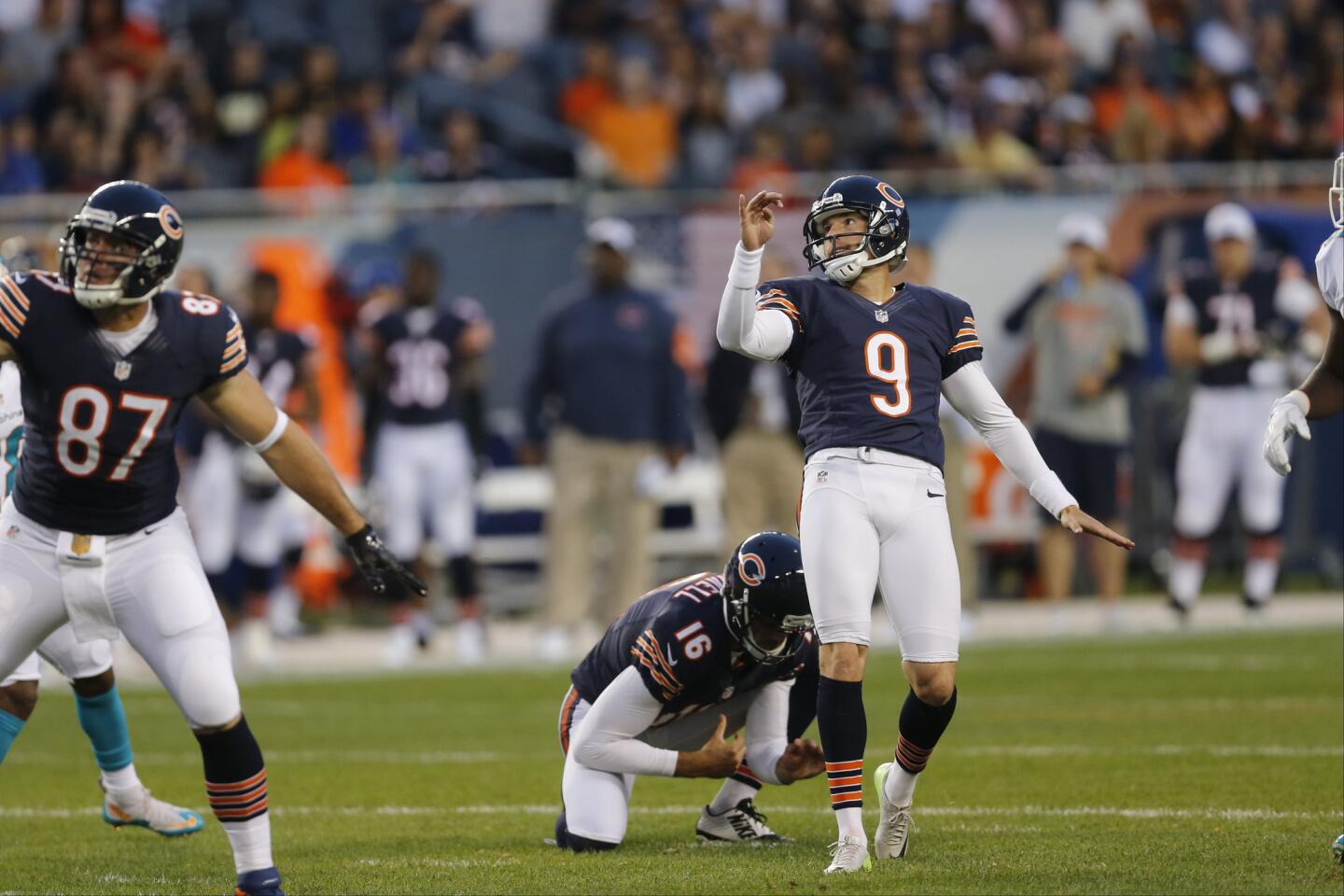 Robbie Gould kicks a field goal front he hold of punter Pat O'Donnell during the first half of a preseason game against the Dolphins at Soldier Field.