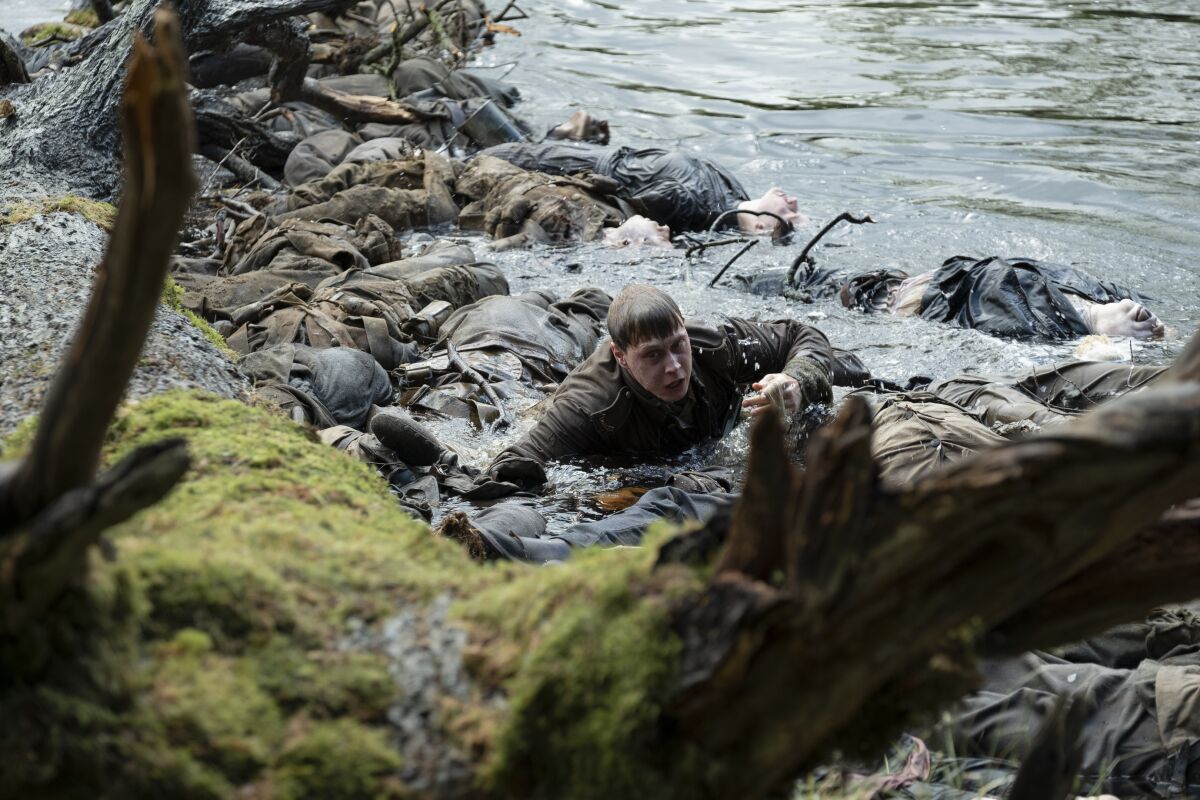 George MacKay emerges from the river in "1917."
