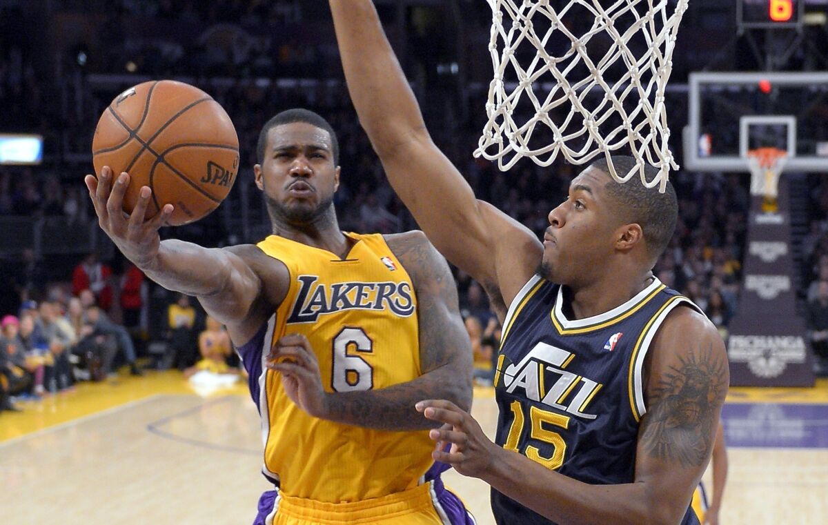 Earl Clark, shown putting up a shot against Utah's Derrick Favors, has averaged 10.6 points and 9.4 rebounds since moving into the Lakers' starting rotation earlier this month.