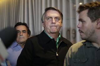 Brazil's former President Jair Bolsonaro prepares to speak to the press at a restaurant in Belo Horizonte, Brazil, Friday, June 30, 2023. The panel of judges voted Friday to render Bolsonaro ineligible to run for office again after concluding that he abused his power and cast unfounded doubts on the country's electronic voting system. (AP Photo/Thomas Santos)