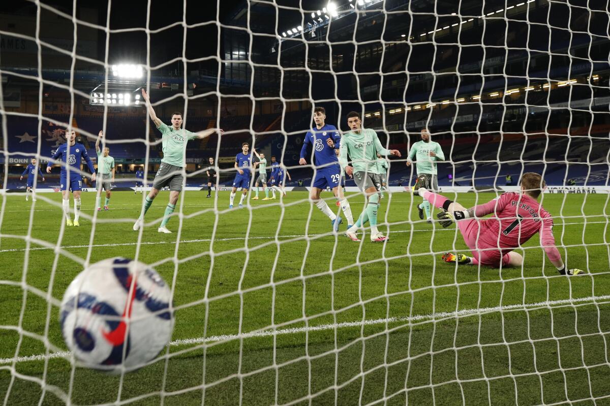 Everton's Ben Godfrey, center, scores an own goal during the English Premier League soccer match between Chelsea and Everton at the Stamford Bridge stadium in London, Monday, March 8, 2021. (John Sibley/Pool via AP)