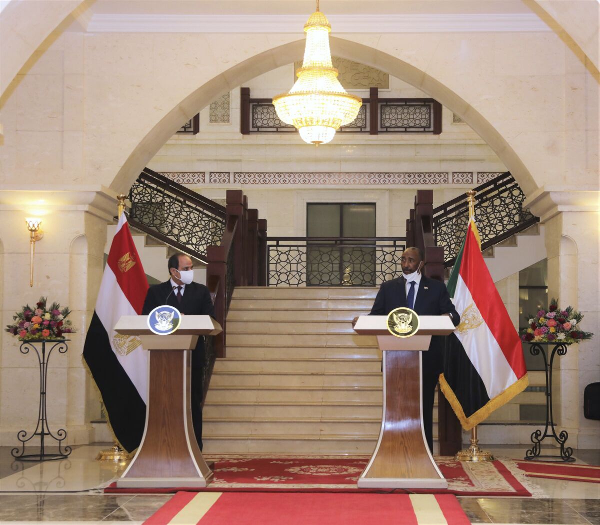 Egyptian President Abdel Fattah al-Sisi meets Chairman of the Sovereignty Council of Sudan Gen. Abdel Fattah Abdelrahman al-Burhan at the Presidential Palace in Khartoum, Sudan, Saturday, March. 6, 2021. Egypt's presidency says President Abdel Fattah el-Sissi trip was to address an array of issues, including economic and military ties and the two nations’ dispute with Ethiopia over a massive dam Addis Ababa is building on the Blue Nile. The visit comes amid a rapprochement between the two governments. (Presidency of Sudan via AP)