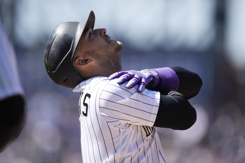 The Rockies' José Iglesias reacts after connecting for an RBI single against the Dodgers on April 8, 2022, in Denver.