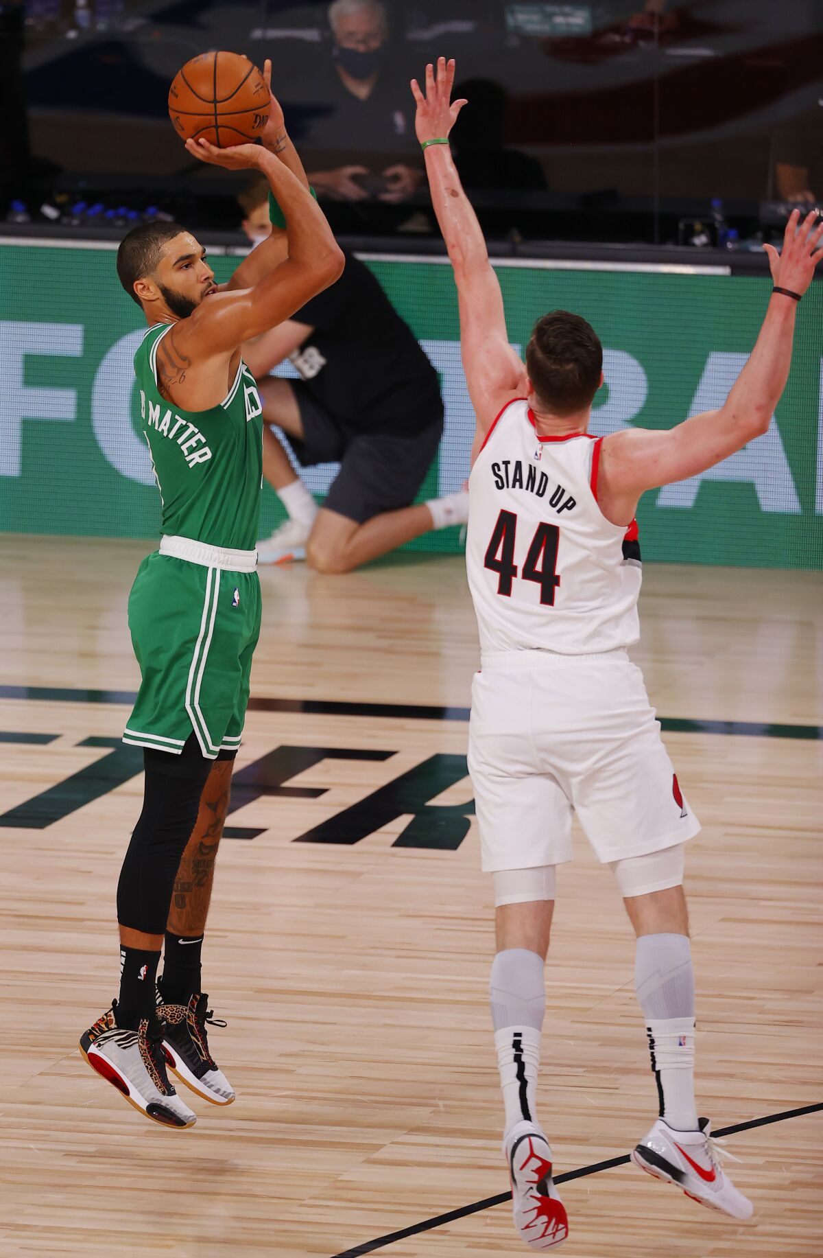 Boston Celtics' Jayson Tatum (0) shoots against Portland Trail Blazers' Mario Hezonja (44) during an NBA basketball game Sunday, Aug. 2, 2020, in Lake Buena Vista, Fla. (Mike Ehrmann/Pool Photo via AP)
