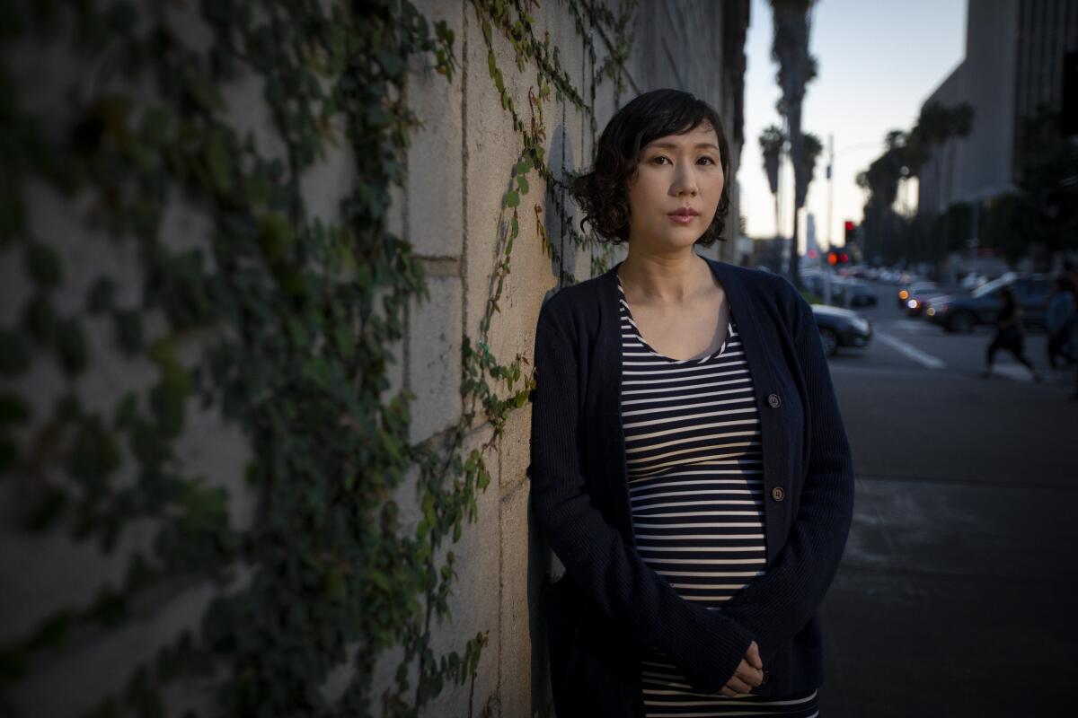 Novelist Steph Cha is shown here in a Koreatown neighborhood. Her novels in the crime fiction genre are about her detective protagonist, Juniper Song.