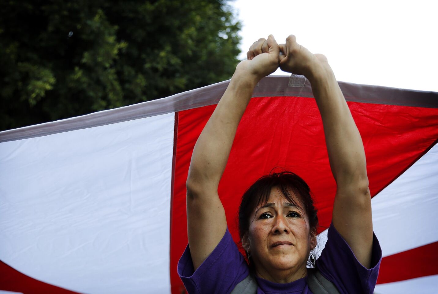 Maria Estrada of Justice for Janitors holds a flag during a May Day March along Temple Street in downtown Los Angeles.