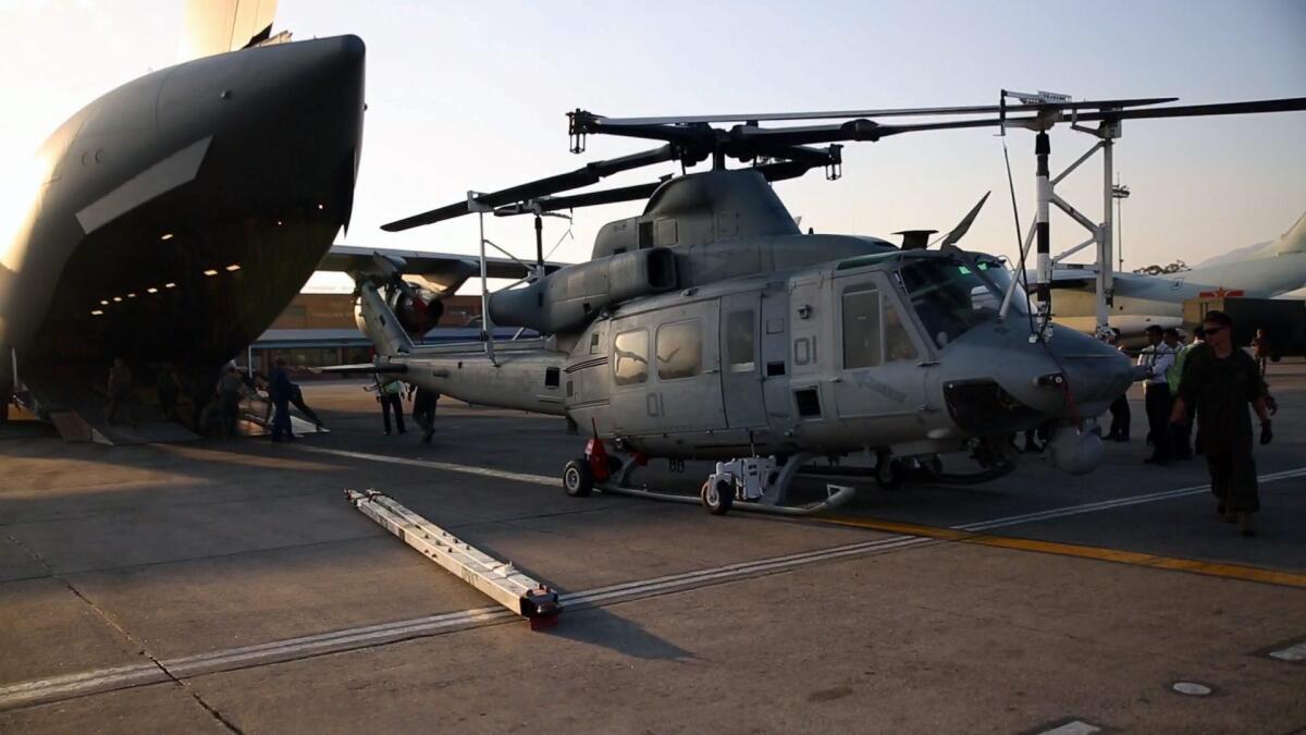 A Marine UH-1Y Huey helicopter is unloaded from a transport plane at the airport in Katmandu, Nepal. A Huey has gone missing during the eartquake relief mission.
