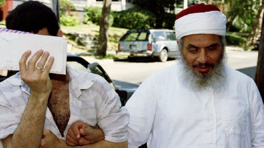 Sheik Omar Abdul Rahman, right, and an unidentified man walk together in New Jersey in 1993. Abdul Rahman, the Egyptian-born cleric linked to the 1993 World Trade Center bombing, died Saturday.