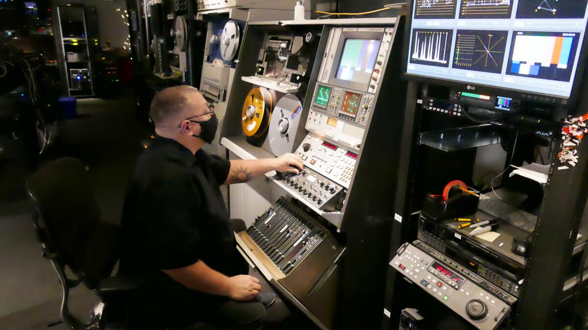 Kurt Spada, lead encode operator at Iron Mountain Entertainment Services, digitizes a two-inch video reel.