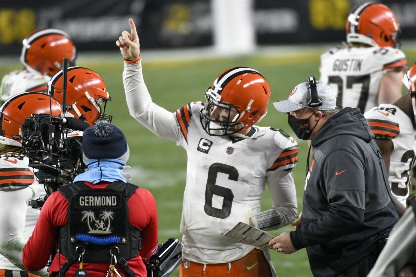 Cleveland Browns offensive coordinator Alex Van Pelt, right, talks with quarterback Baker Mayfield.