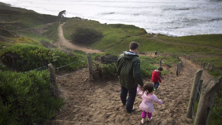 Visitors walk down the sand ladder to the beach at Fort Funston, part of the Golden Gate National Recreation Area in San Francisco. Volunteers may lend a hand at the park's nursery on National Public Lands Day on Saturday.