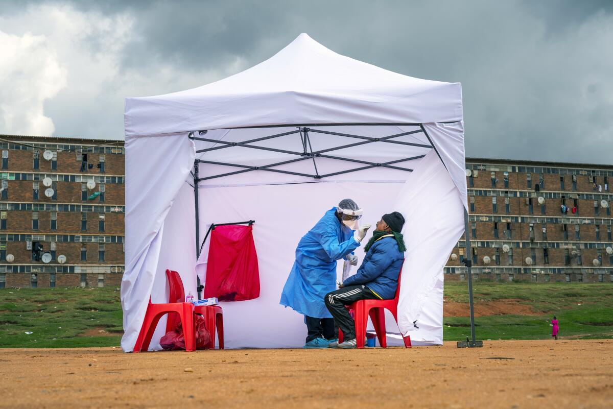 A person gets tested for COVID-19 in a tent 