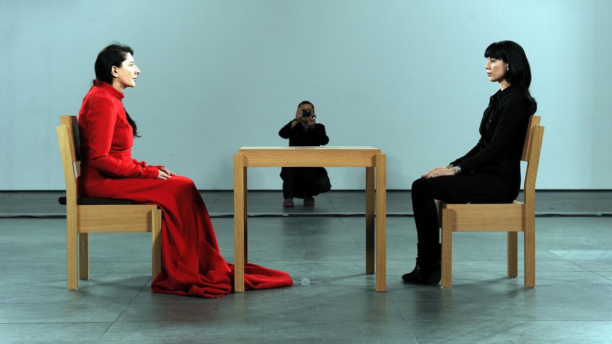 Marina Abramovic, left, during her performance 'The Artist is Present'