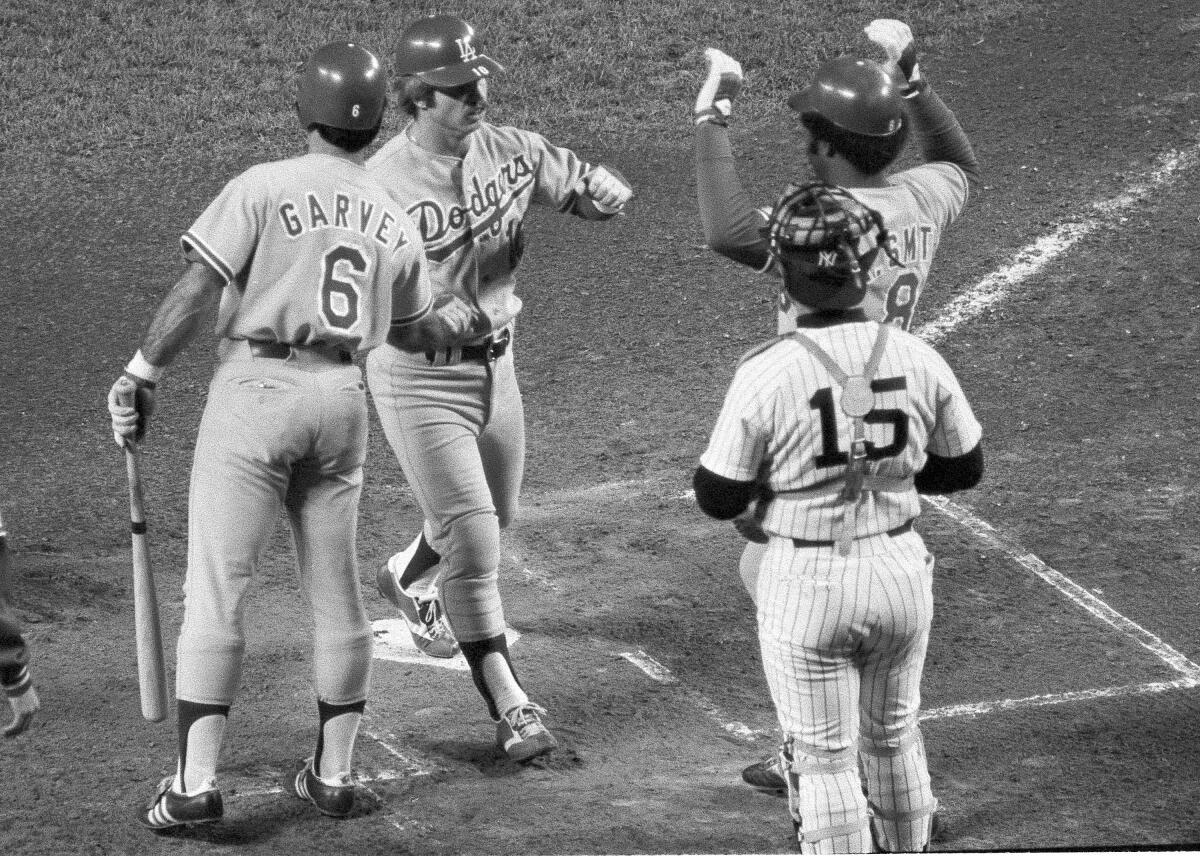 The Dodgers' Ron Cey is congratulated by teammates Steve Garvey, left, and Reggie Smith after hitting a home run.