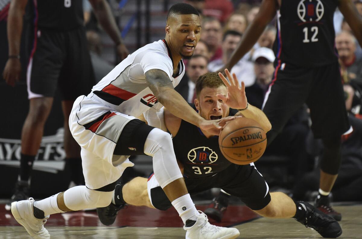 Trail Blazers guard Damian Lillard (0) and Clippers forward Blake Griffin (32) go after a loose ball in the first quarter of Game 4.