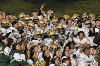 St. Bonaventure players celebrate after a 21-20 win over St. Augustine, winning the game with no time left.