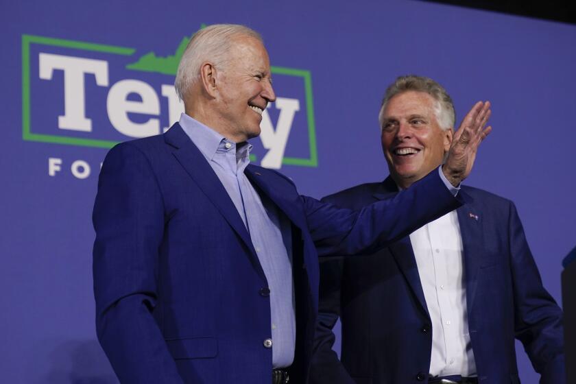 President Joe Biden stands with Virginia democratic gubernatorial candidate Terry McAuliffe during a campaign event McAuliffe at Lubber Run Park, Friday, July 23, 2021, in Arlington, Va. (AP Photo/Andrew Harnik)