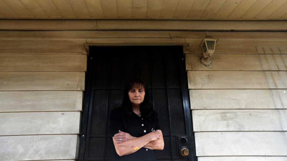 Joan Winget stands outside her home in Sun Valley, which sits near the 5 Freeway. To protect herself from car and truck pollution, she keeps her doors and windows closed and runs the air conditioning nonstop.
