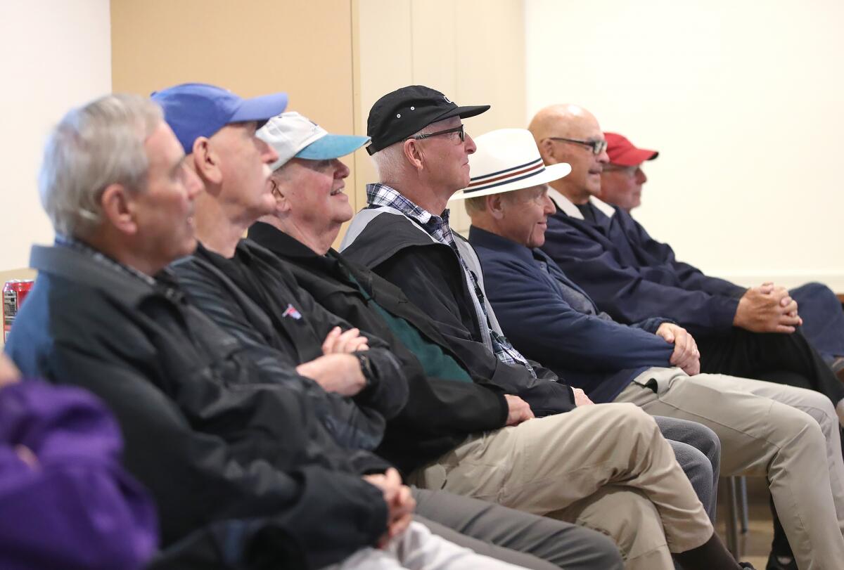 Guests of the Tackling Sports group listen to Scott Daruty at the Oasis Senior Center.