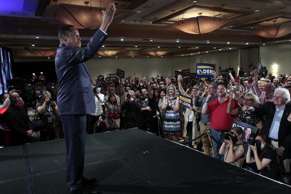 Recall candidate Larry Elder rallies supporters at the Hilton in Costa Mesa on Tuesday.
