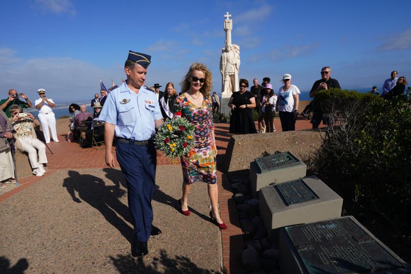 San Diego, CA - September 29: At the Cabrillo National Monument on Friday, Sept. 29, 2023, in San Diego, CA, Rosaura Morrow Picasso and Col. Francisco Martin-Alonso of the Spanish Air Force placed a wreath at the plaque to honor the 481st anniversary of Juan Rodriguez Cabrillo as the first European to set foot on the west coast of the United States. (Nelvin C. Cepeda / The San Diego Union-Tribune)