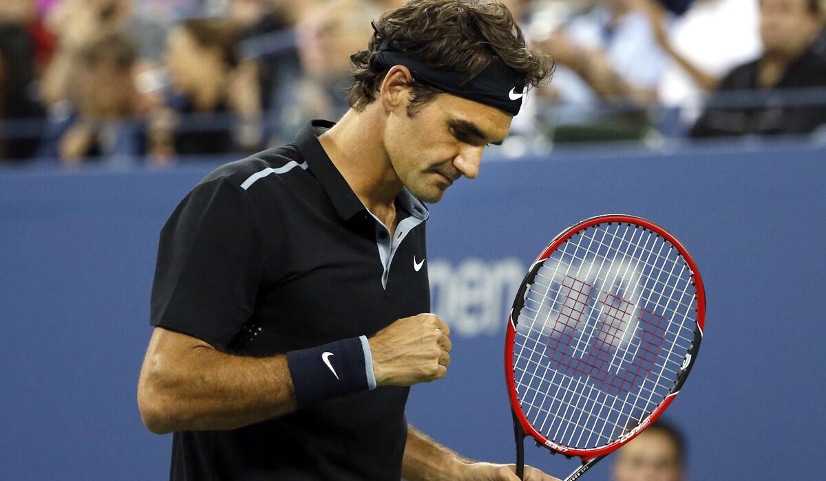 Roger Federer reacts after winning a point against Sam Groth in the second round of the U.S. Open on Friday.