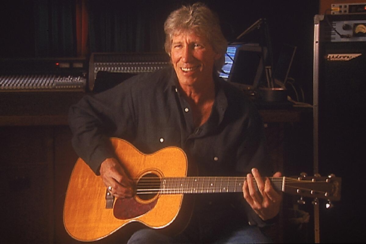 Roger Waters playing acoustic guitar in "Classic Albums Pink Floyd - Dark Side of the Moon" on PBS.