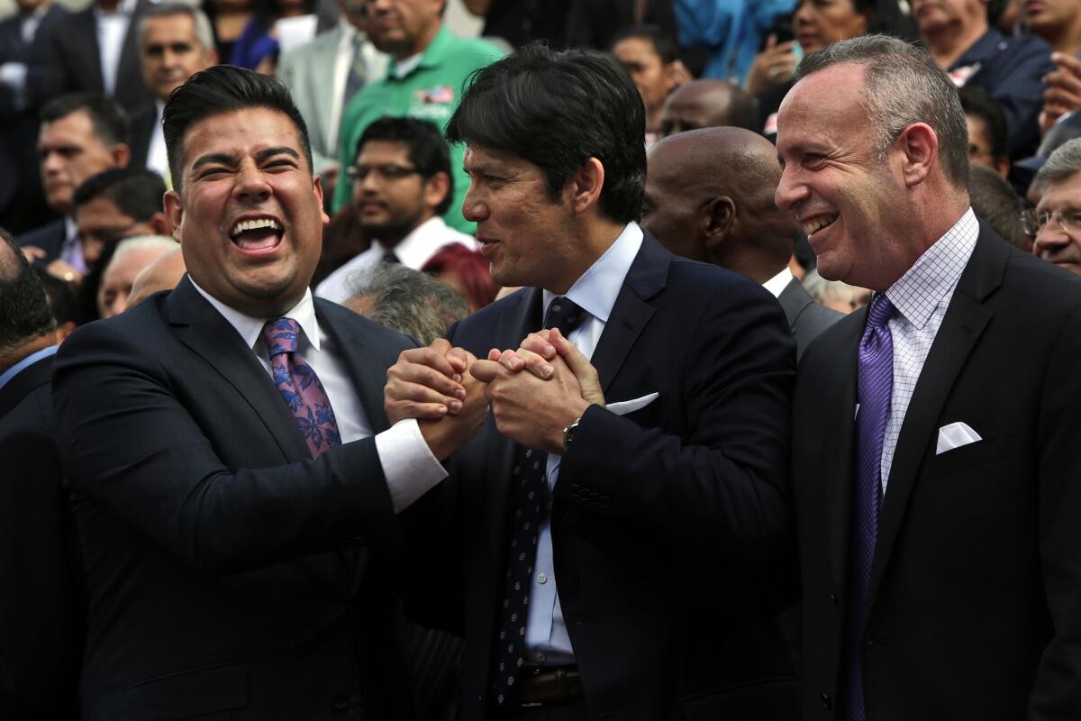 State Sen. Ricardo Lara (D-Bell Gardens), left, Sen. Kevin de Leon (D-Los Angeles) and Senate President Pro Tem Darrell Steinberg (D-Sacramento) celebrate a bill signing last year. Steinberg's support for turning over Senate leadership to De Leon this year has sparked a debate over power sharing.
