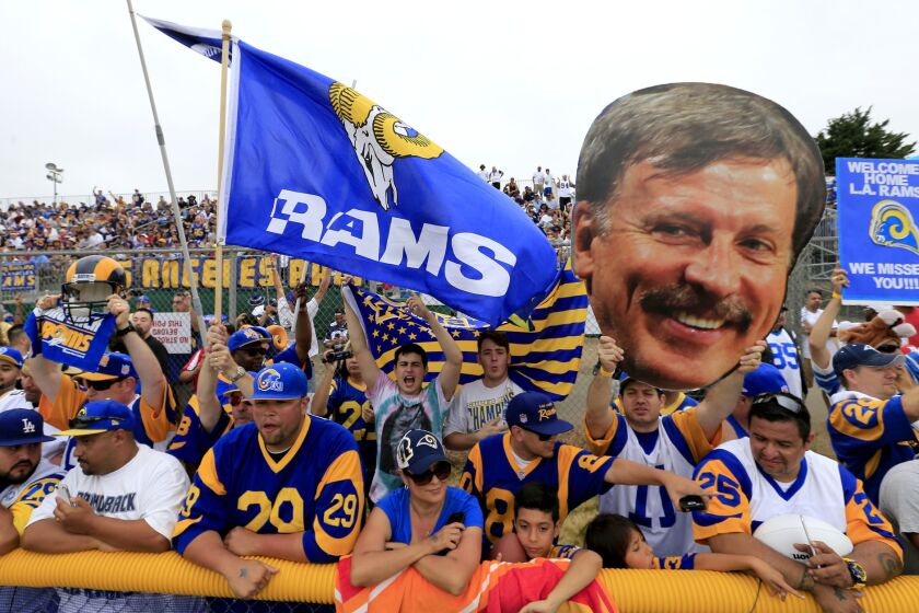Tom Bateman, with his Stan Kroenke image in tow, joins other Rams fans in Oxnard to watch the team participate in a joint training session with the Dallas Cowboys.