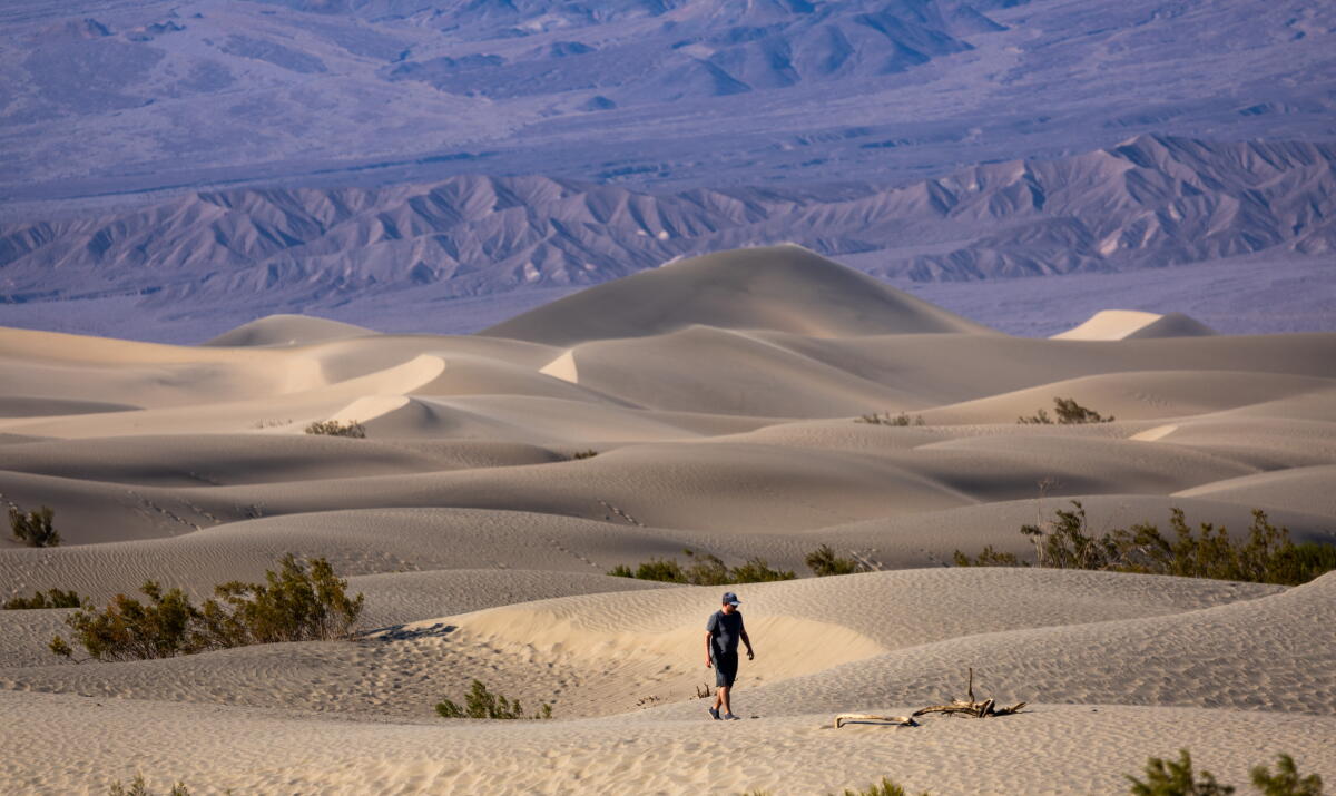 A man hikes in Death Valley National Park.