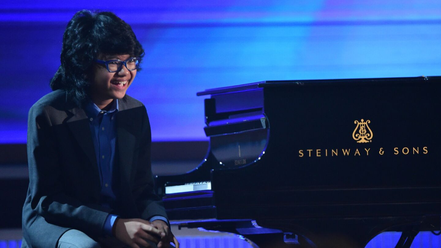 Twelve-year-old jazz pianist Joey Alexander smiles as the audience cheers after his performance.