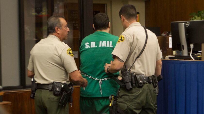 Jon David Guerrero, who is charged with multiple homicides and attacks on homeless people and others, is escorted out of a San Diego courtroom after his arraignment in April 2017.