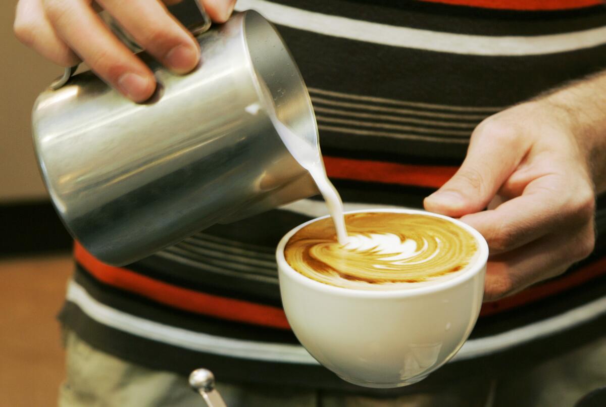 Un trabajador prepara una bebida de café en una tienda en Overland Park, Kansas, 