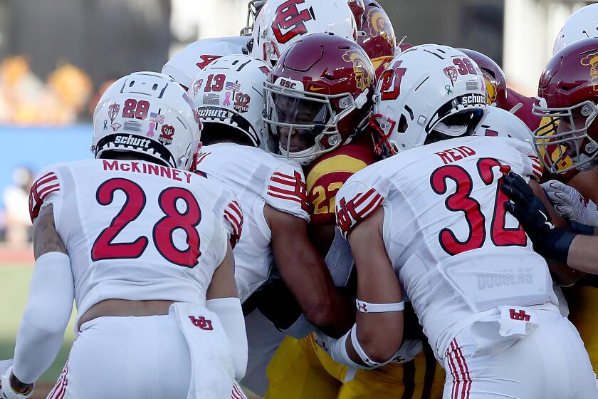 LOS ANGELES, CALIF. - OCT. 9, 2021. USC tailback Darwin Barlow gets wrapped up by the Utah defense.