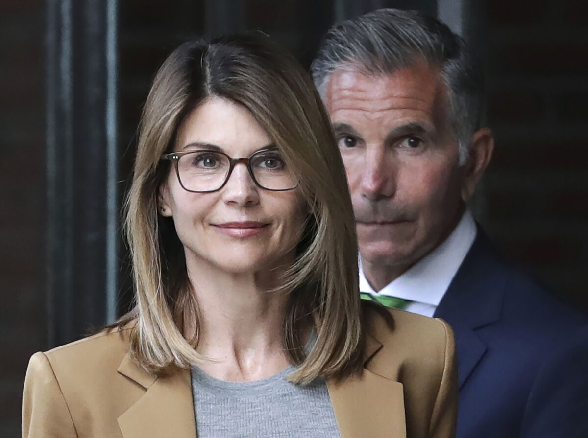 Actress Lori Loughlin and husband Mossimo Giannulli leave a federal courthouse in Boston in April 2019. The couple have agreed to plead guilty in the college admissions scam.