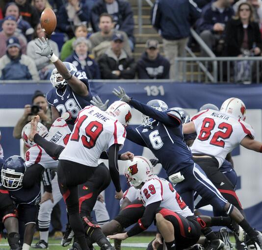 UConn's Jasper Howard, (6), right, a 5-foot-9, 174-pound starting cornerback on the UConn football team, moves in on Louisville kicker Ryan Payne as he attempts a field goal in the first half of the UConn/ Louisville game at Rentschler Field Saturday afternoon. Hours later, just after midnight, Howard was stabbed to death outside of the UConn Student Union building.