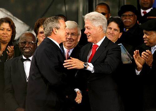 President Bush is greeted by former President Bill Clinton at the ground breaking ceremony for a memorial to Martin Luther King, Jr.